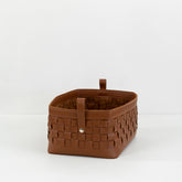 Kara hand-woven bridle leather basket used as stylish storage in a luxury home office setting